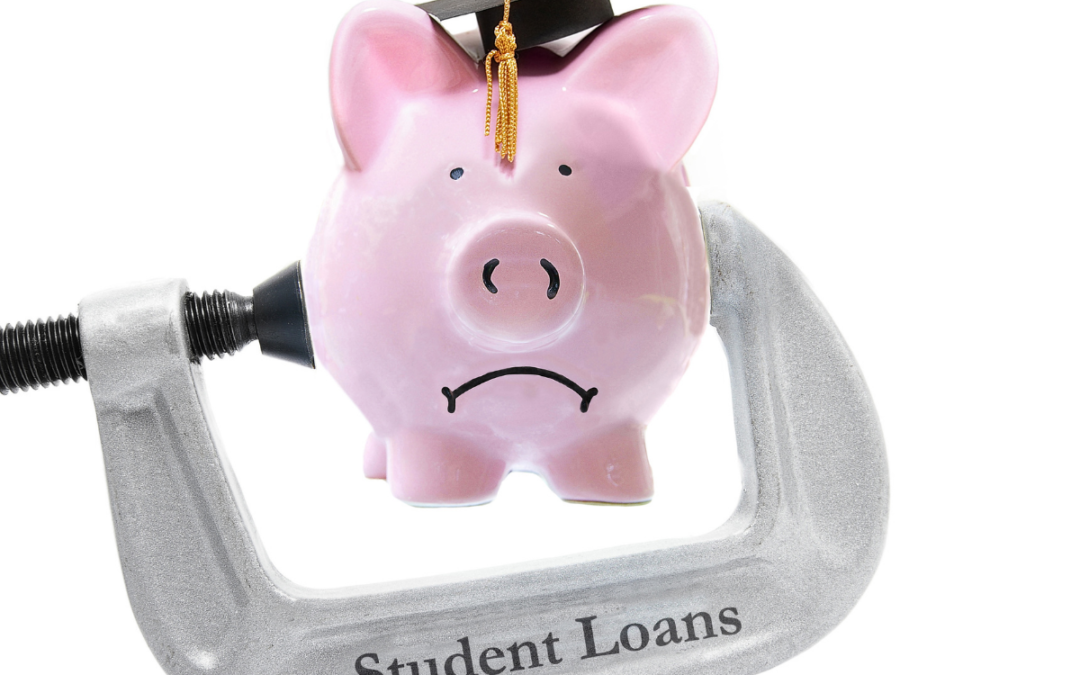 piggybank with graduation cap in student loan vise